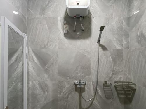 a bathroom with a shower and a sink and a toilet at RedDoorz @ Green Homestay Syariah Baubau in Baubau