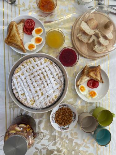 a table with a breakfast of eggs bread and toast at Гостевой дом “Kyzyl Alma” (Red Apple) in Chon-Dzhargylchak