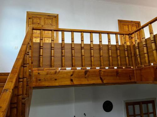 a wooden staircase in a room with at Гостевой дом “Kyzyl Alma” (Red Apple) in Chon-Dzhargylchak