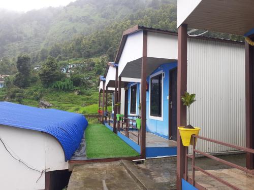 a house with a blue cover on the side of it at Lake Haven Resort, Sari, Chopta in Sari