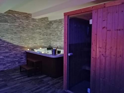 a bathroom with a sink and a brick wall at Cosykaza - SPA - Sauna - Hammam 