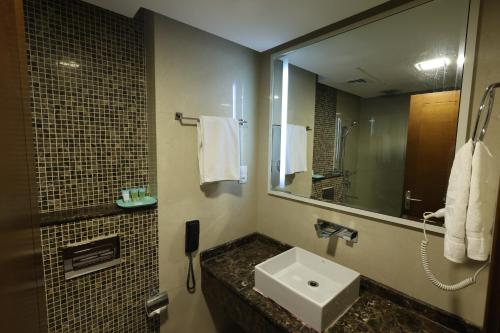 a bathroom with a sink and a mirror at The Bristol Inn Hotel in Dubai