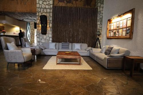 a living room with couches and a coffee table at Taita Hills Safari Resort & Spa in Tsavo