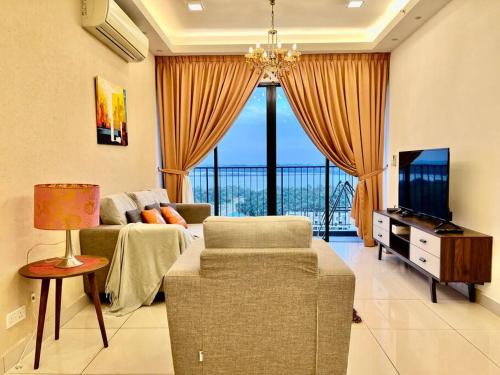 a living room with a couch and a tv at Citrine Hub in Sunway Iskandar by Cowidea in Kampong Pendas