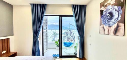 a bedroom with a window with a view of a bathroom at STAR APARTMENT- BEACH FRONT in Quy Nhon