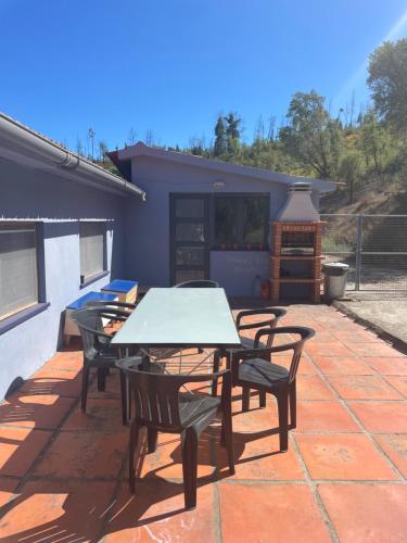 a patio with a table and chairs and a grill at Quinta do Eco in Vila de Rei