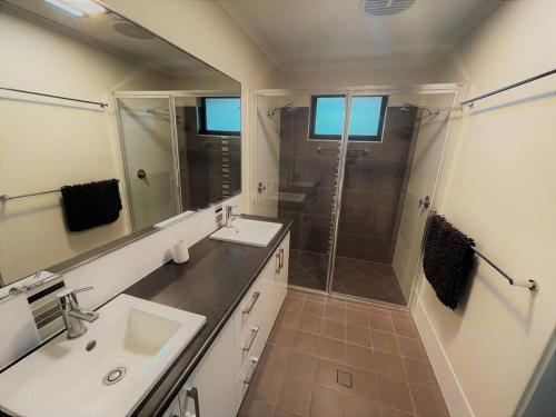 a bathroom with a shower and a sink and a mirror at Shore Beats Workin in Esperance