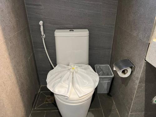 a bathroom with a toilet with a towel on it at Sokchea Kampot Hotel in Kampot