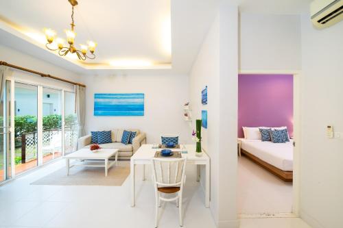 a living room with a bed and a couch at Blu Marine Hua Hin Resort and Villas - SHA Plus in Hua Hin