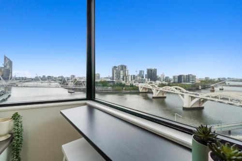 a view of a river from a window at Brisbane Riverside Retreat in Brisbane