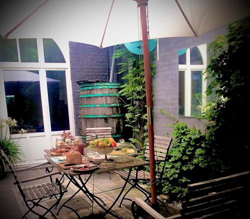 a table with fruit on it with an umbrella at Casa Lucinda in Ghent