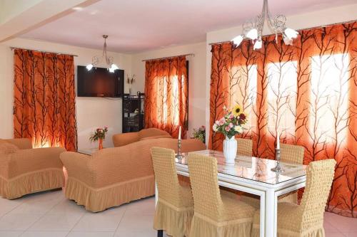 a dining room with a glass table and chairs at Villa Spiros in Ioannina