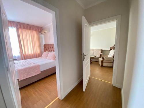 an open door to a bedroom with a bed and a couch at Wild Cherry 2 bedroom Apartament Economy-1 in Varna City
