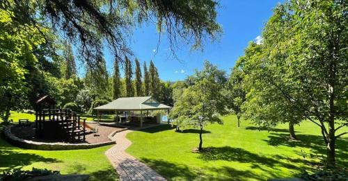 a park with a playground and a gazebo at Chestnut Tree Holiday Units in Bright