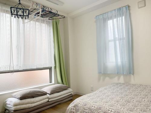 a bedroom with a bed and a large window at ookubo! 大久保! 新宿步行距离! 精品新装公寓! 大久保车站步行7分钟! 干湿分离! 智能马桶! 高速无限制网路 201 in Tokyo