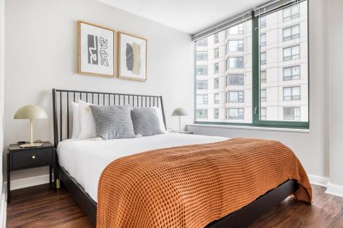 a bedroom with a bed and a large window at Streeterville Studio w Dog Run Deck nr Park CHI-584 in Chicago