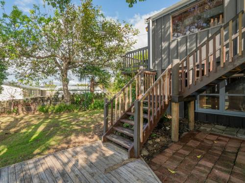 a staircase leading up to a house at Paku View Retreat - Tairua Holiday Home in Tairua