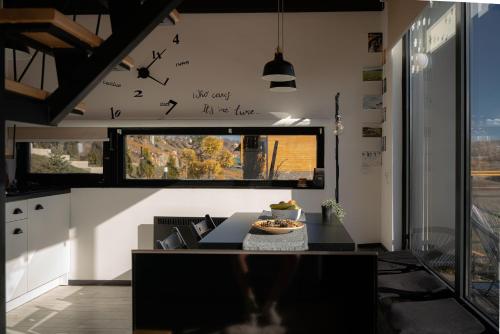 a kitchen with a table and a window with birds on the wall at Wild nest Deer Lux in Zlatibor