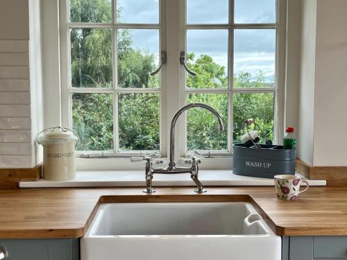 a kitchen with a sink and a window at Cobblers Lodge in Lyme Regis