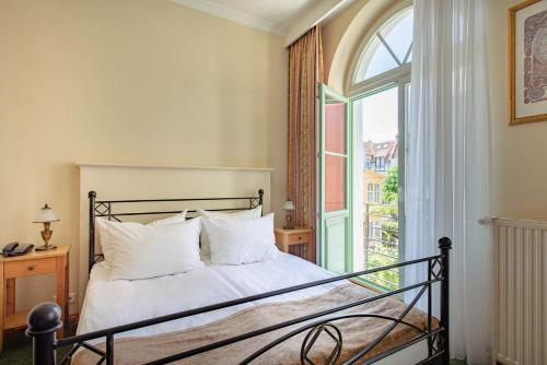 a bedroom with a bed and a large window at Villa Sedan in Sopot