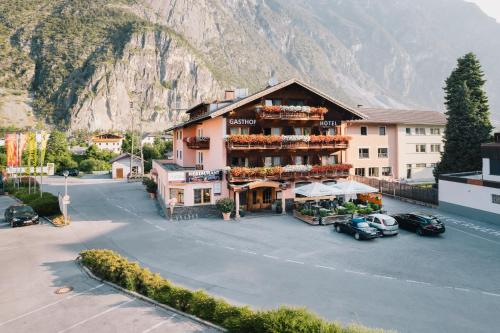 a building on the side of a street with a mountain at Hotel Andrea in Zams
