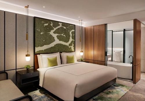 a bedroom with a large bed and a bath tub at Taj The Trees, Mumbai in Mumbai