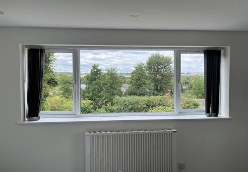 a window in a room with a radiator and a view at Studio apartment in Harefield in Harefield
