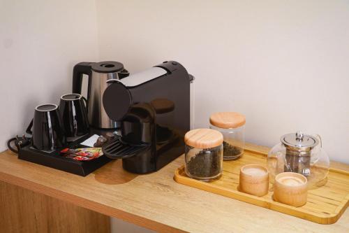 a coffee maker sitting on top of a wooden shelf at Sea Breeze Hotel & Villa in Sihanoukville