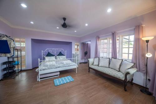 a living room with a bed and a couch at Villa 23 - 4B/4B/PrivatePool/BBQ in Petaling Jaya