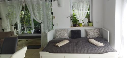 a bedroom with a bed with two pillows on it at Apartmán Mariposa 1 