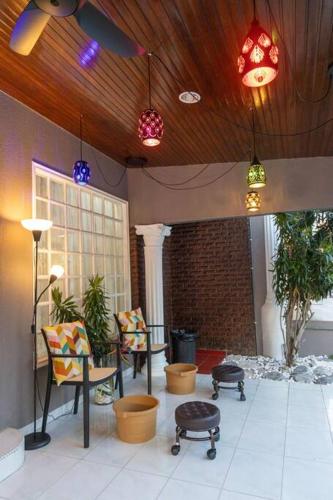 a room with chairs and a table and lights at Villa 23 - 4B/4B/PrivatePool/BBQ in Petaling Jaya