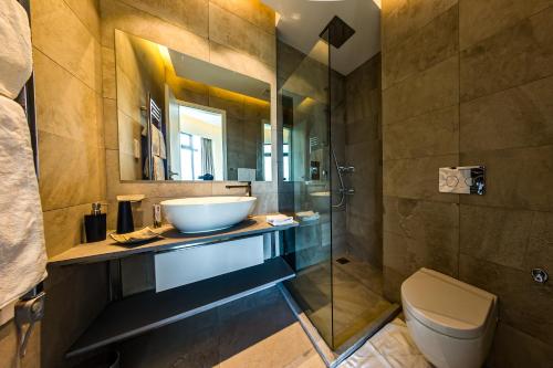 a bathroom with a sink and a toilet and a shower at Prime Living Luxury Apartments in Nairobi