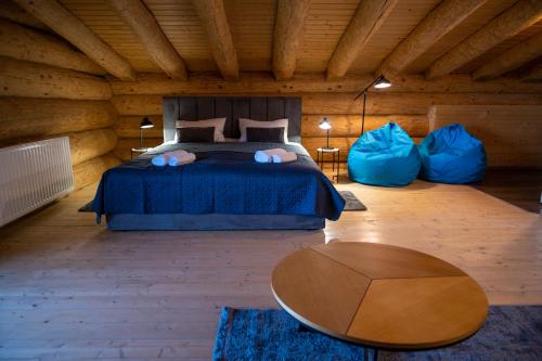 a bedroom with a bed and two blue pillows at Шале PARADISE in Mizhhirʼʼya