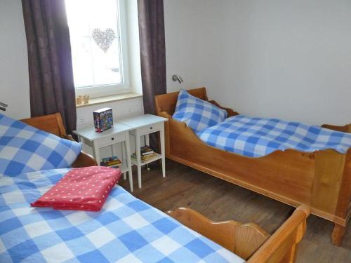 a small room with two beds and a window at Gut Frielinghausen in Meschede