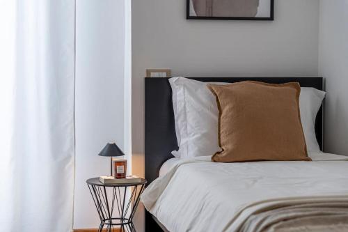 a bedroom with a bed and a side table with a lamp at [Via Indipendenza] – Attico di lusso con Piscina in Bologna