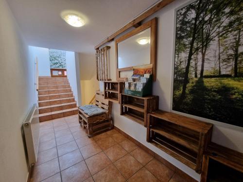 a hallway with stairs and a large painting on the wall at Ferienwohnung Gschwendt in Gföhl