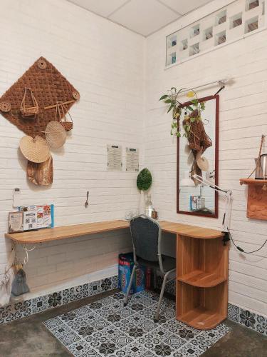 an office with a desk and a mirror on a wall at Mekong Pottery Homestay, Green-Friendly & Boat Tour in Vĩnh Long
