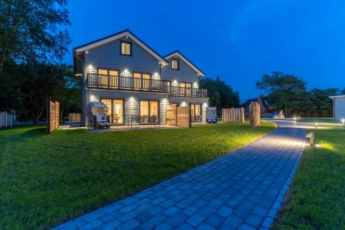 a large house with a walkway in front of it at Lodge54 in Sankt Peter-Ording