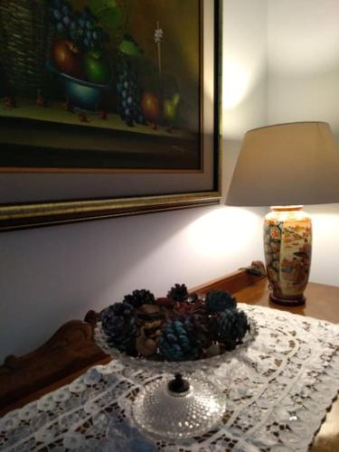 a glass bowl on a table next to a lamp at Nostalgia Apartments B Plus in Sami 50 meters from the sea in Sami