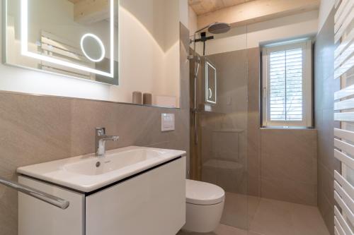a bathroom with a white sink and a toilet at Lodge54 in Sankt Peter-Ording