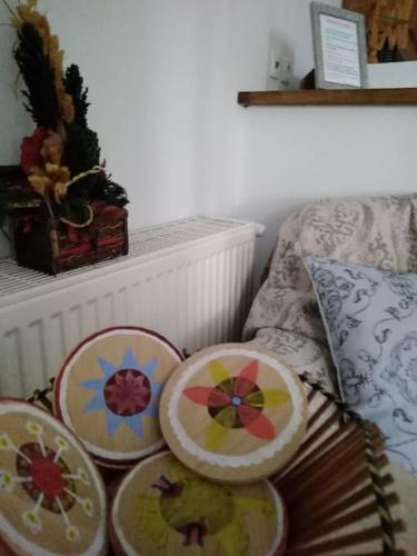three embroidered plates sitting on a bed next to a pillow at Nostalgia Apartments B Plus in Sami 50 meters from the sea in Sami