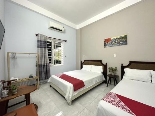 a bedroom with two beds and a window at OYO 1187 Suoi Da Motel in Da Nang