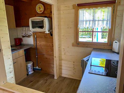 a small kitchen in a log cabin with a window at Zur Sonne in Freest