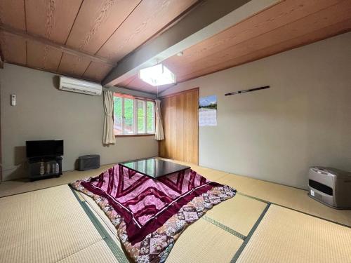 a room with a glass table in the middle of it at Narusawaso in Narusawa