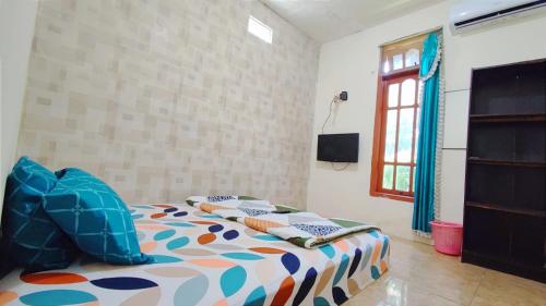 a bedroom with a bed with pillows on it at West Surabaya Homey in Surabaya