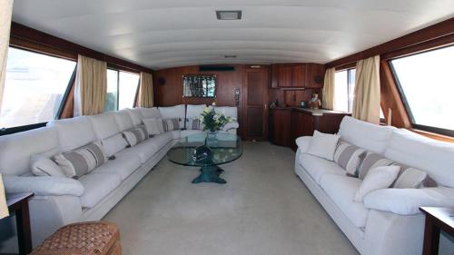 a living room with white couches and a table at Hotel Yacht Our Alissa in Barcelona