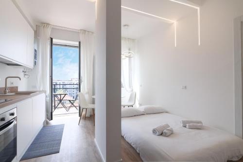 1 dormitorio con 1 cama y cocina con balcón en PrimoPiano - Padova 320, en Milán
