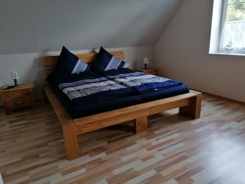 a bed with blue pillows on it in a room at Ferienwohnung Mangelsen in Gelting