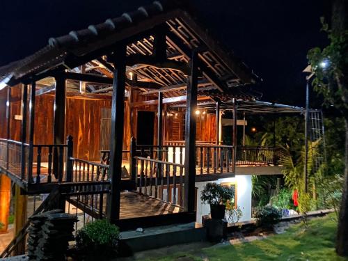 a house with a large deck at night at Homestay Highland Vân Hòa Phú Yên in Tuy Hoa