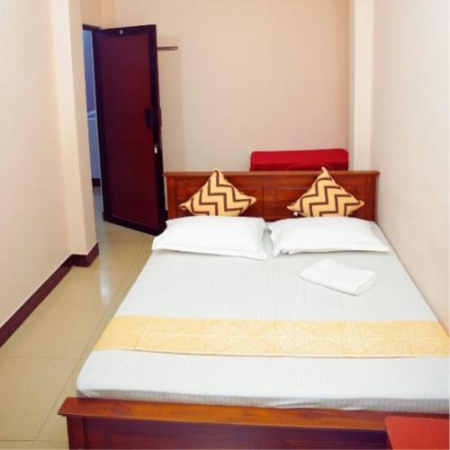 Postel nebo postele na pokoji v ubytování RJ City Hotel